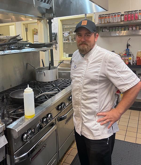 Sous chef Brandon Schultek smiling in a kitchen